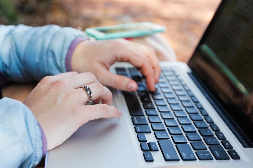 Person busy entering information into laptop computer