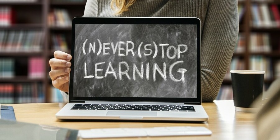 A picture of a laptop with the words on the screen saying 'never stop learning'